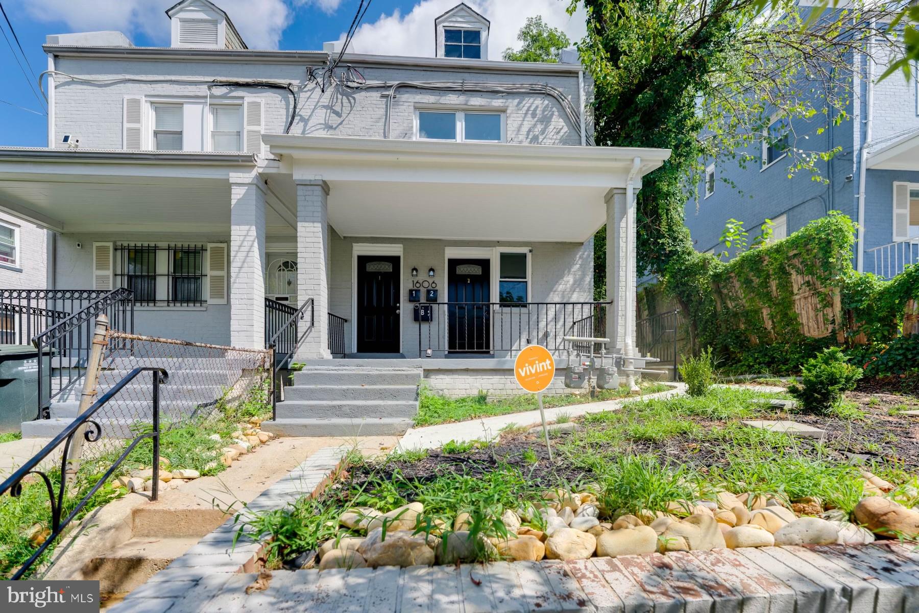 a view of a house with outdoor seating area and garden