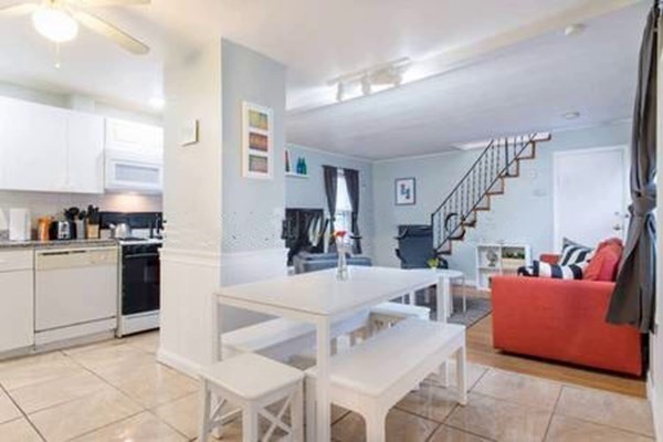 a living room with furniture and kitchen view