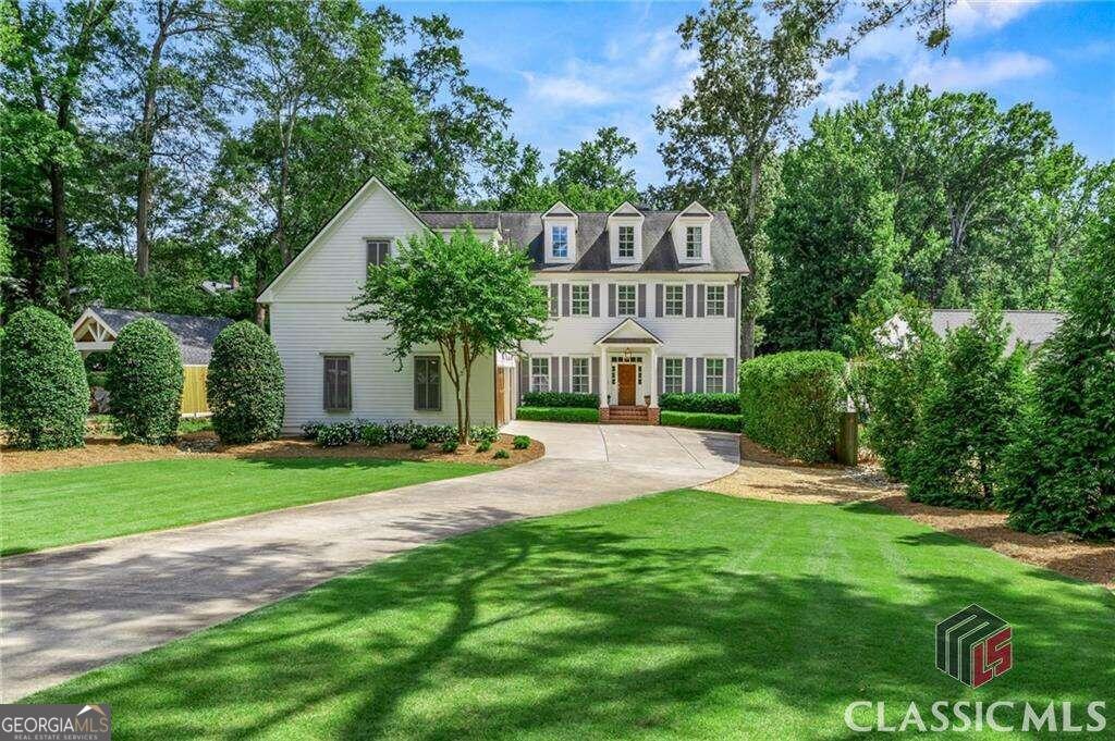 a front view of a house with a yard and porch