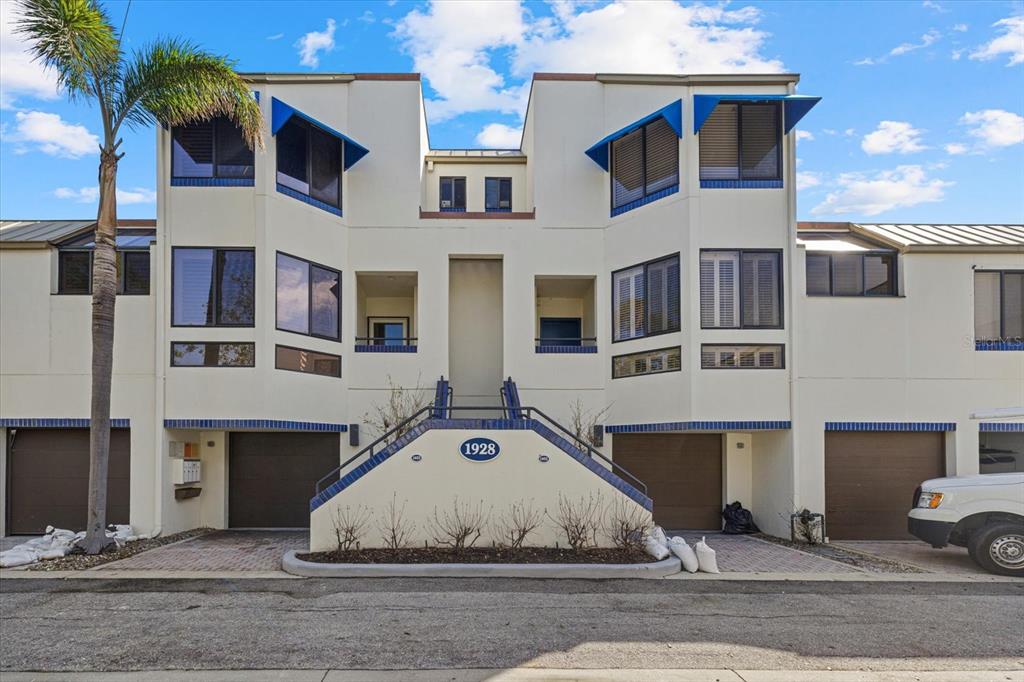 a white building sitting in front of a building