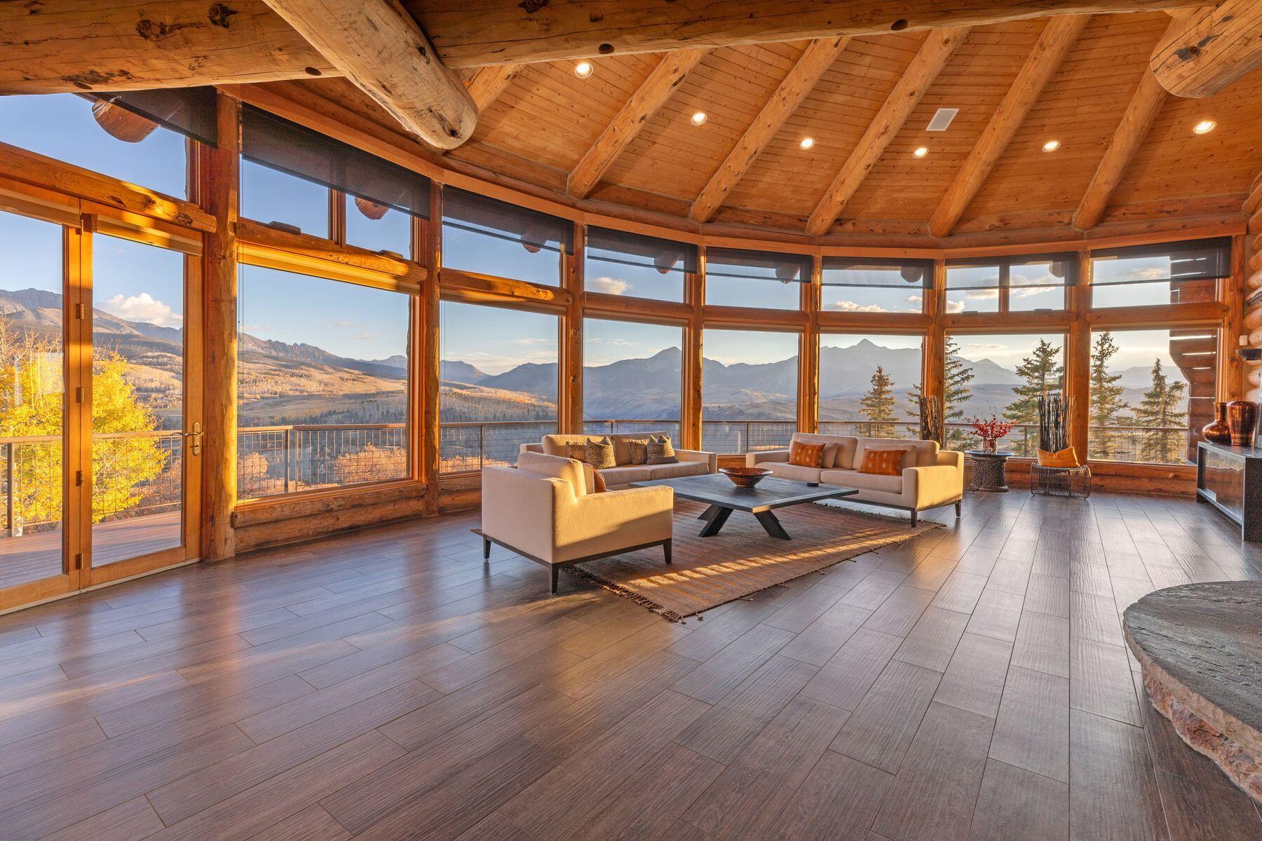 a living room with furniture and floor to ceiling windows