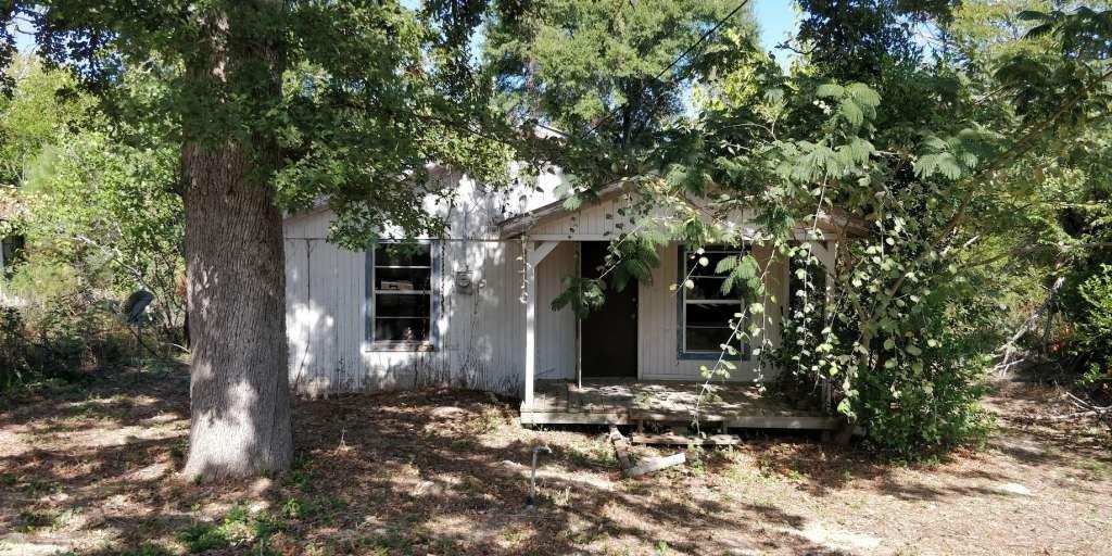 a view of a house with a tree