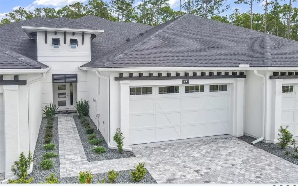 a view of a house with a backyard