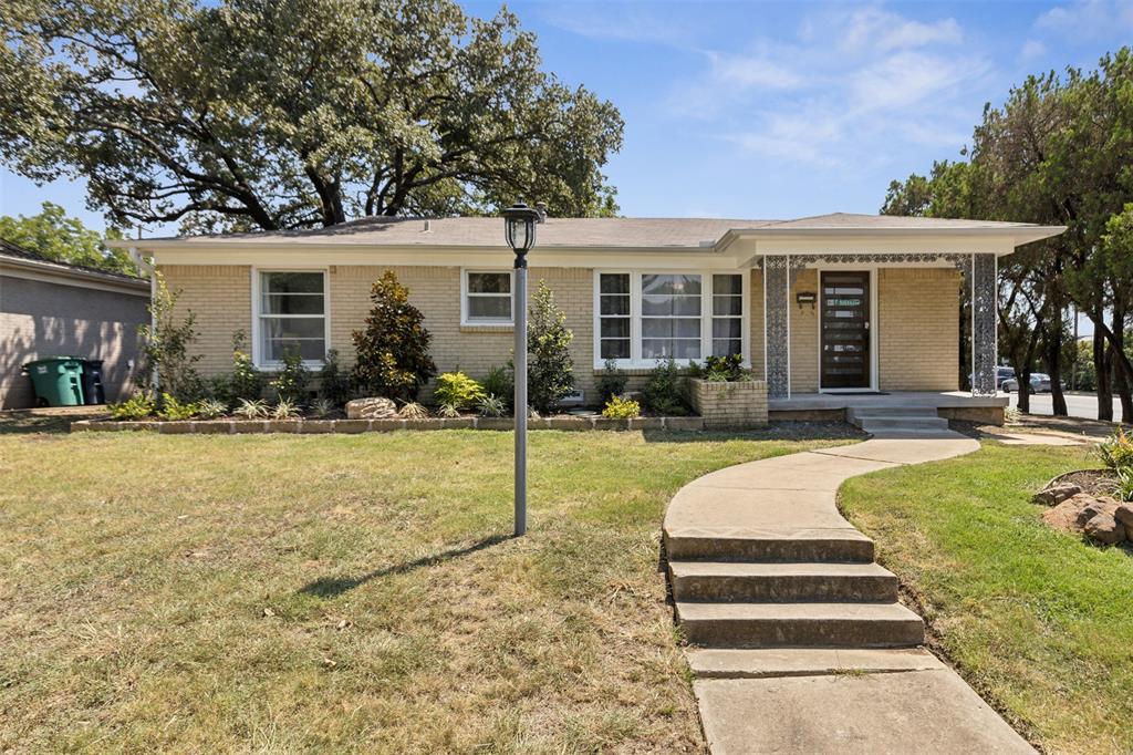 a front view of house with yard patio and outdoor seating