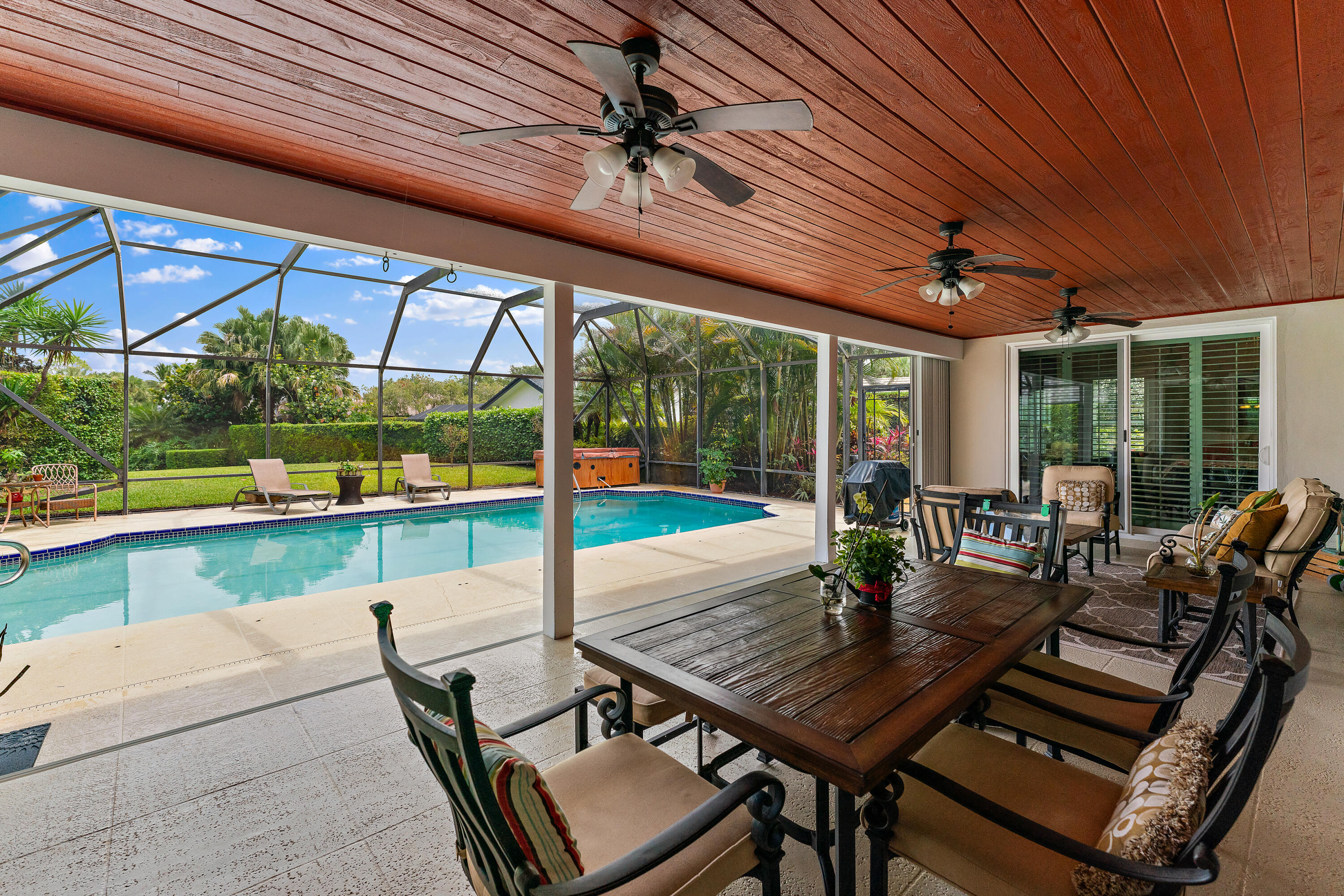 a view of backyard with swimming pool and outdoor seating