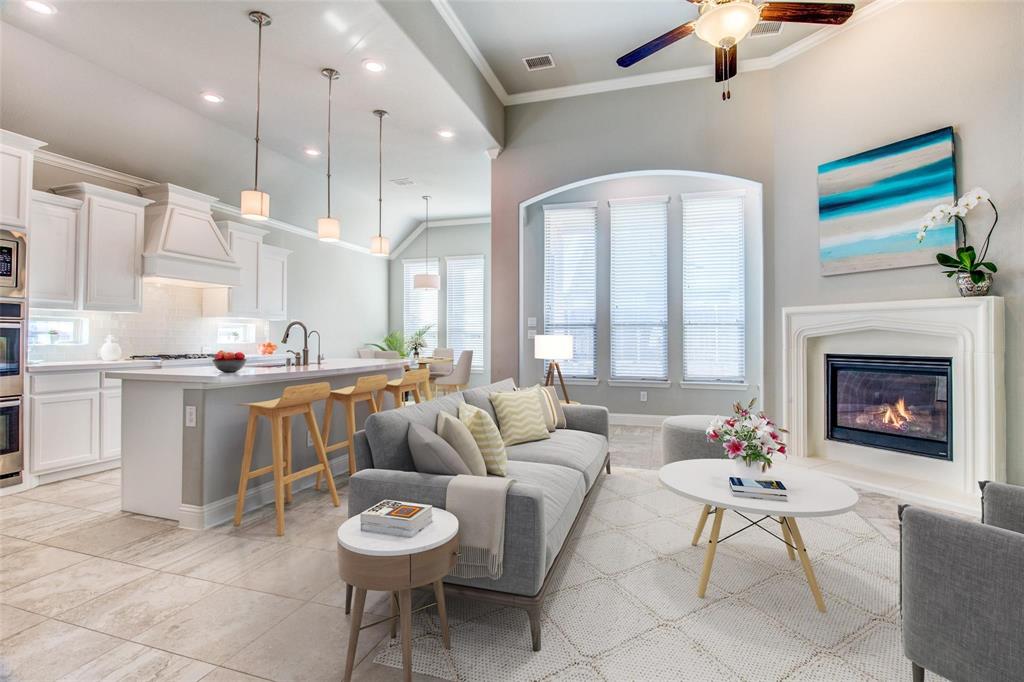 a living room with furniture a fireplace and a chandelier