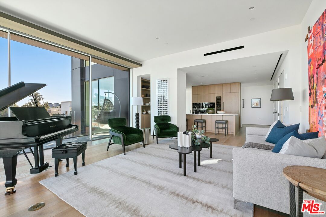 a living room with furniture and a painting on the wall