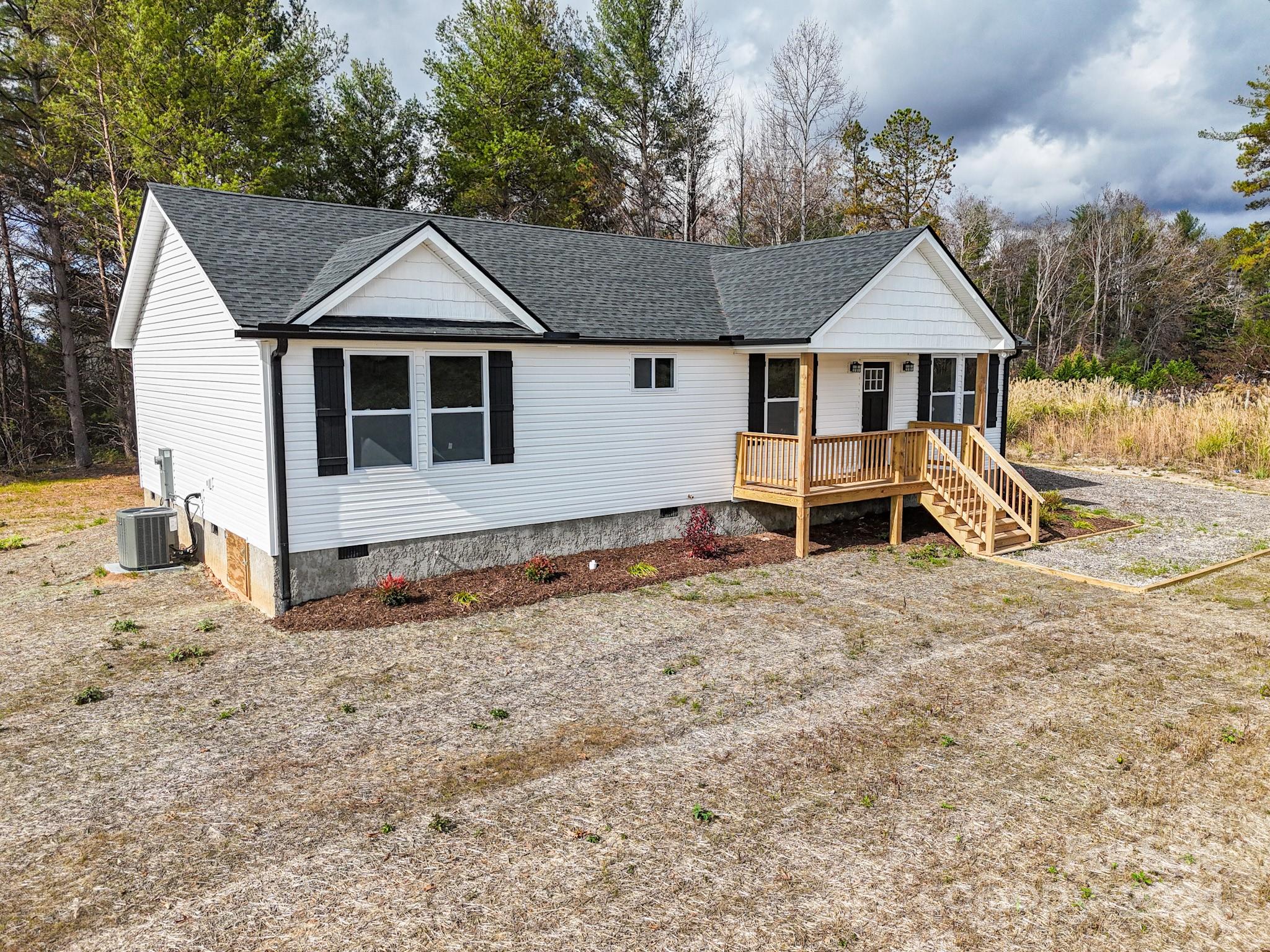 a view of a house with wooden fence