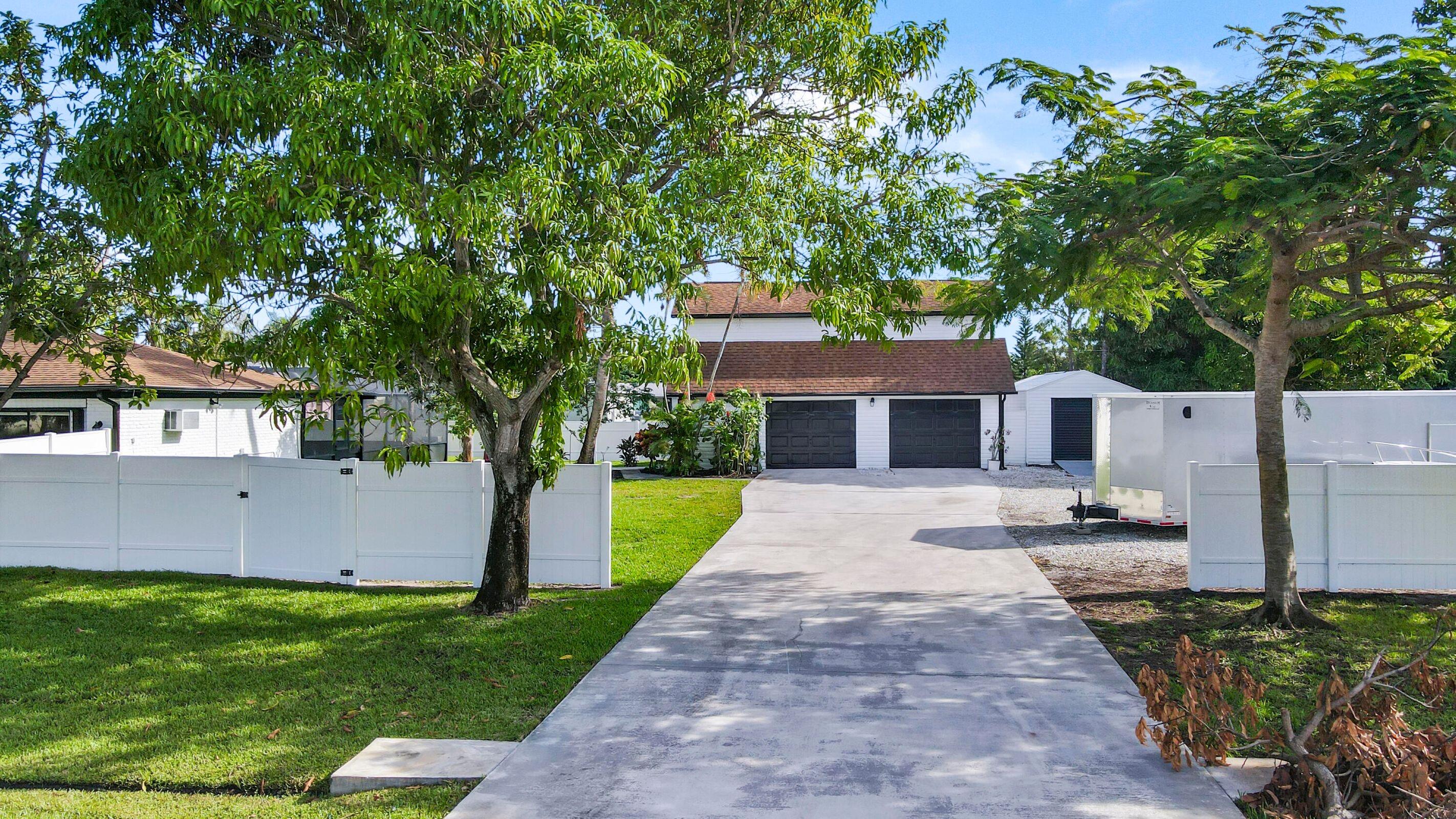 a front view of a house with a yard and a garage