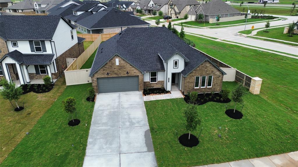 an aerial view of a house with a yard