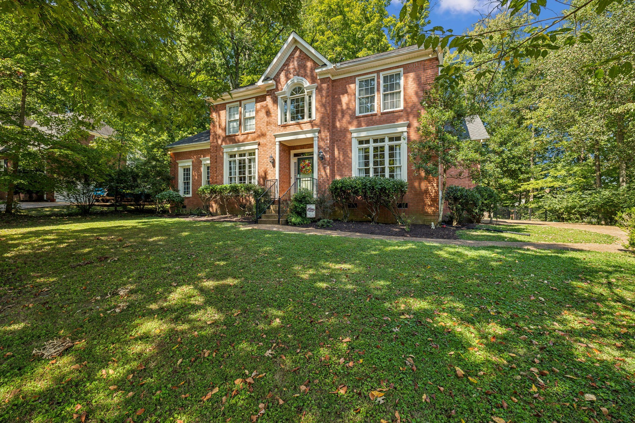 a front view of a house with a yard