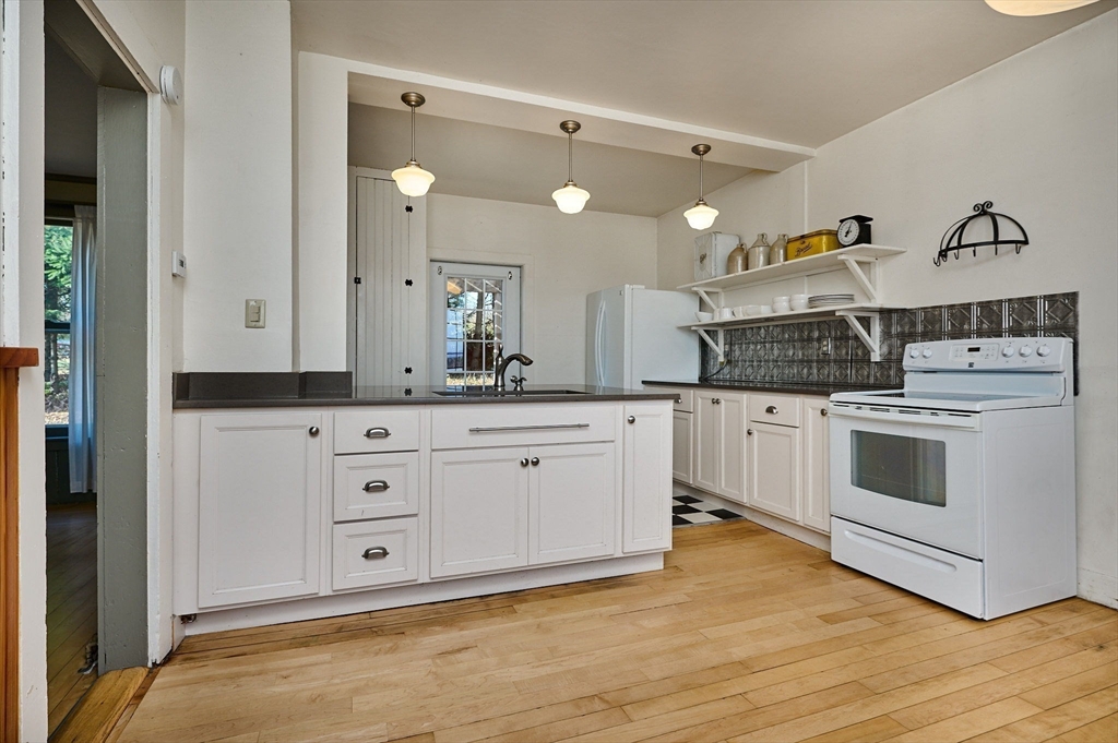 a kitchen with white cabinets and white appliances