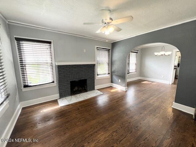 a view of a livingroom with wooden floor and a fireplace