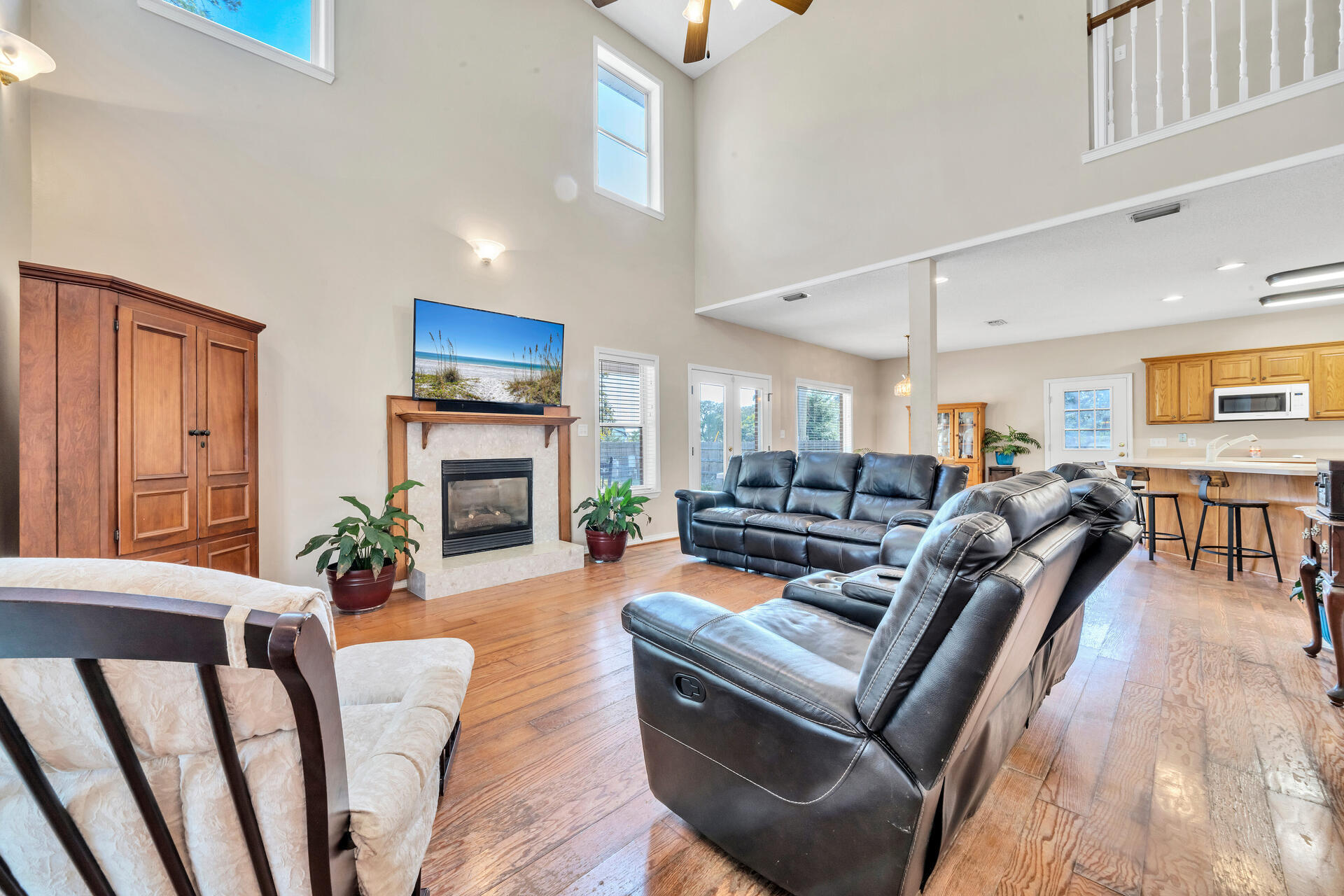 a living room with furniture fireplace and wooden floor