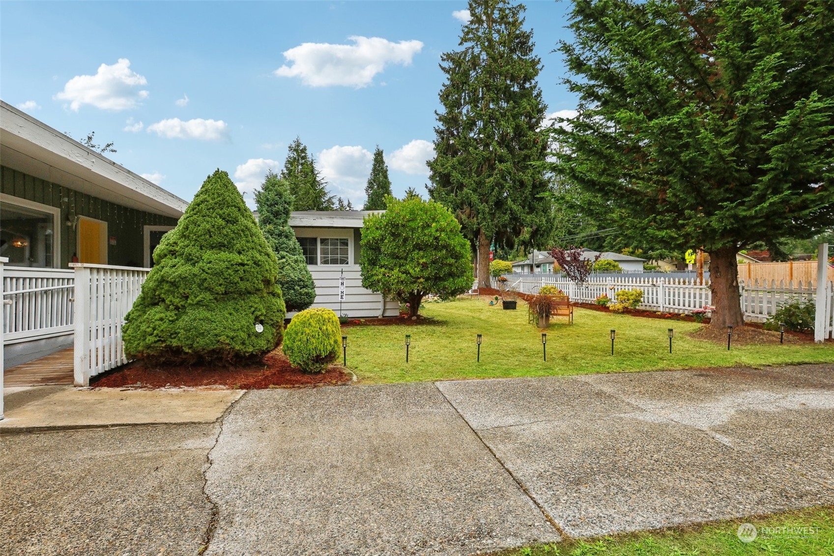 a view of a house with a yard and a garage