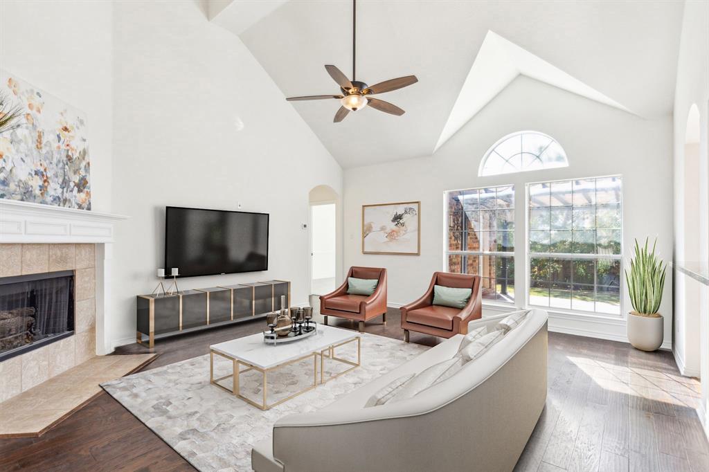 a living room with furniture a fireplace and a flat screen tv