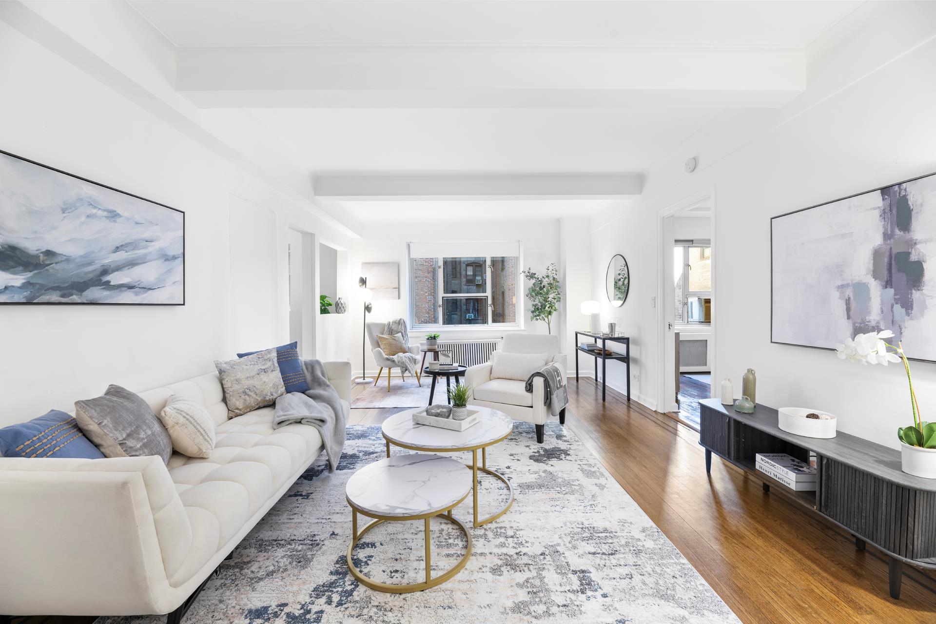 a living room with furniture and wooden floor