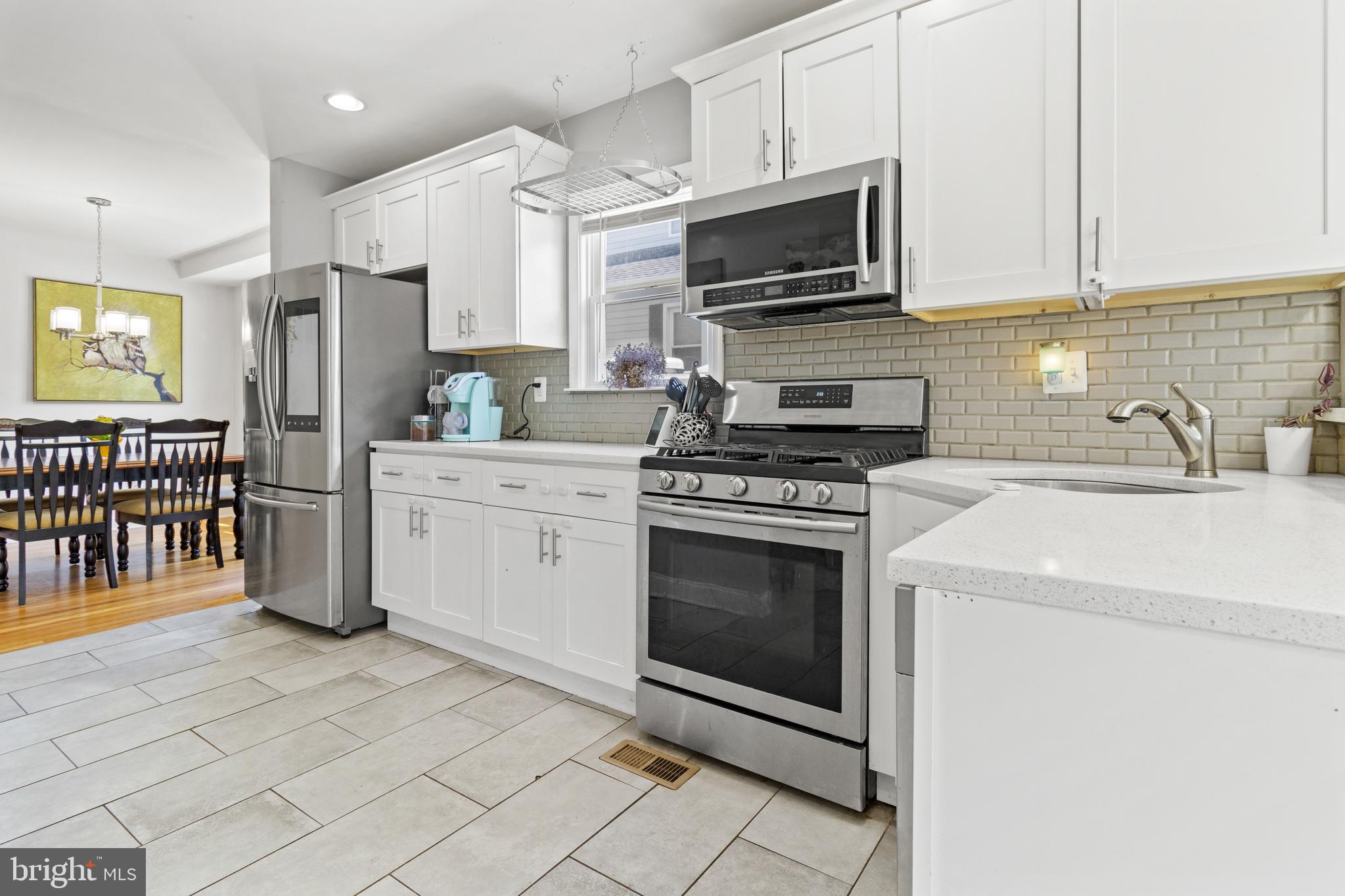 a kitchen with stainless steel appliances a stove a sink a microwave and cabinets