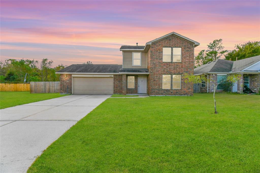 a front view of house with yard and green space