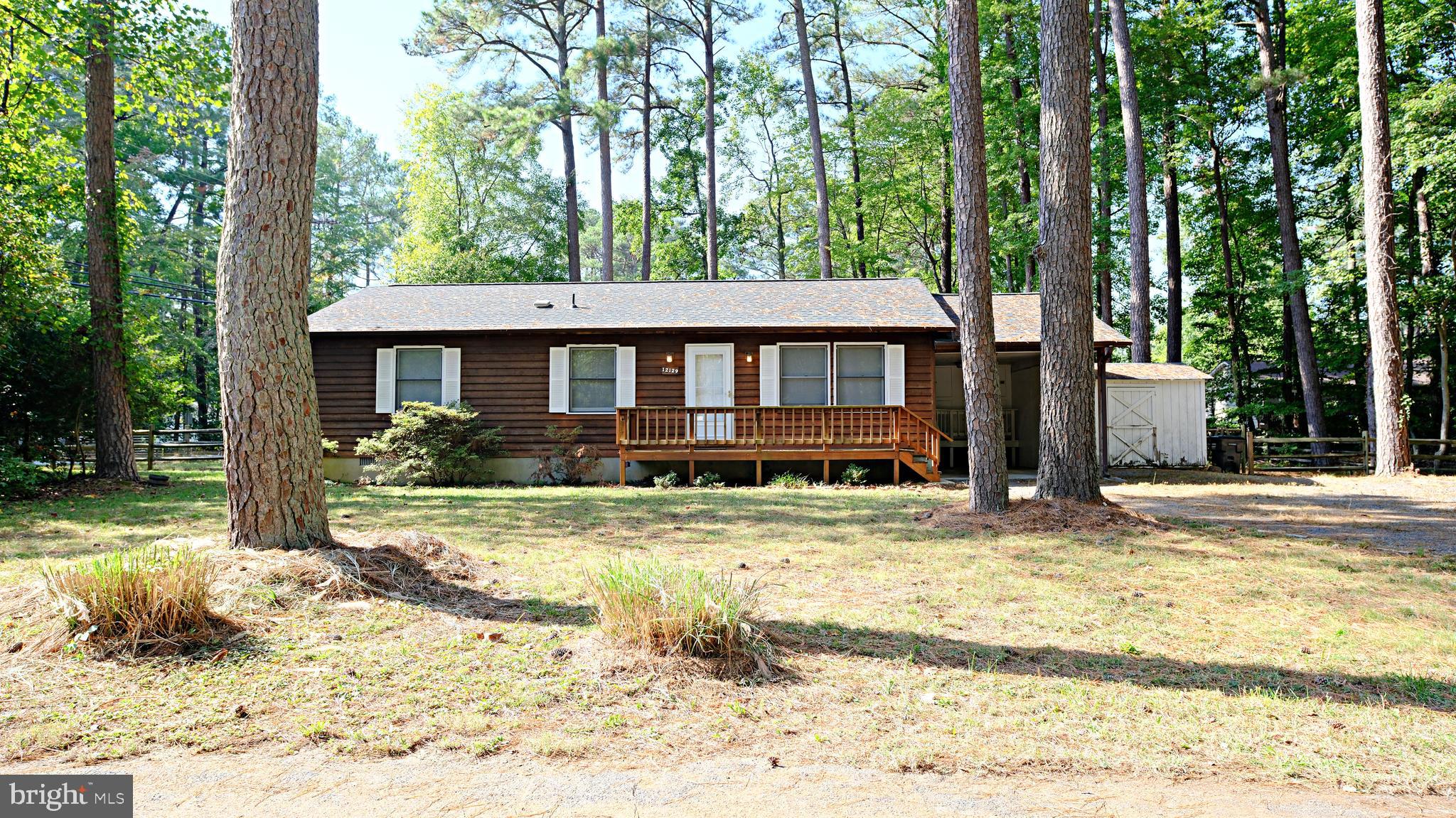 a view of a house with a yard siting area and garden