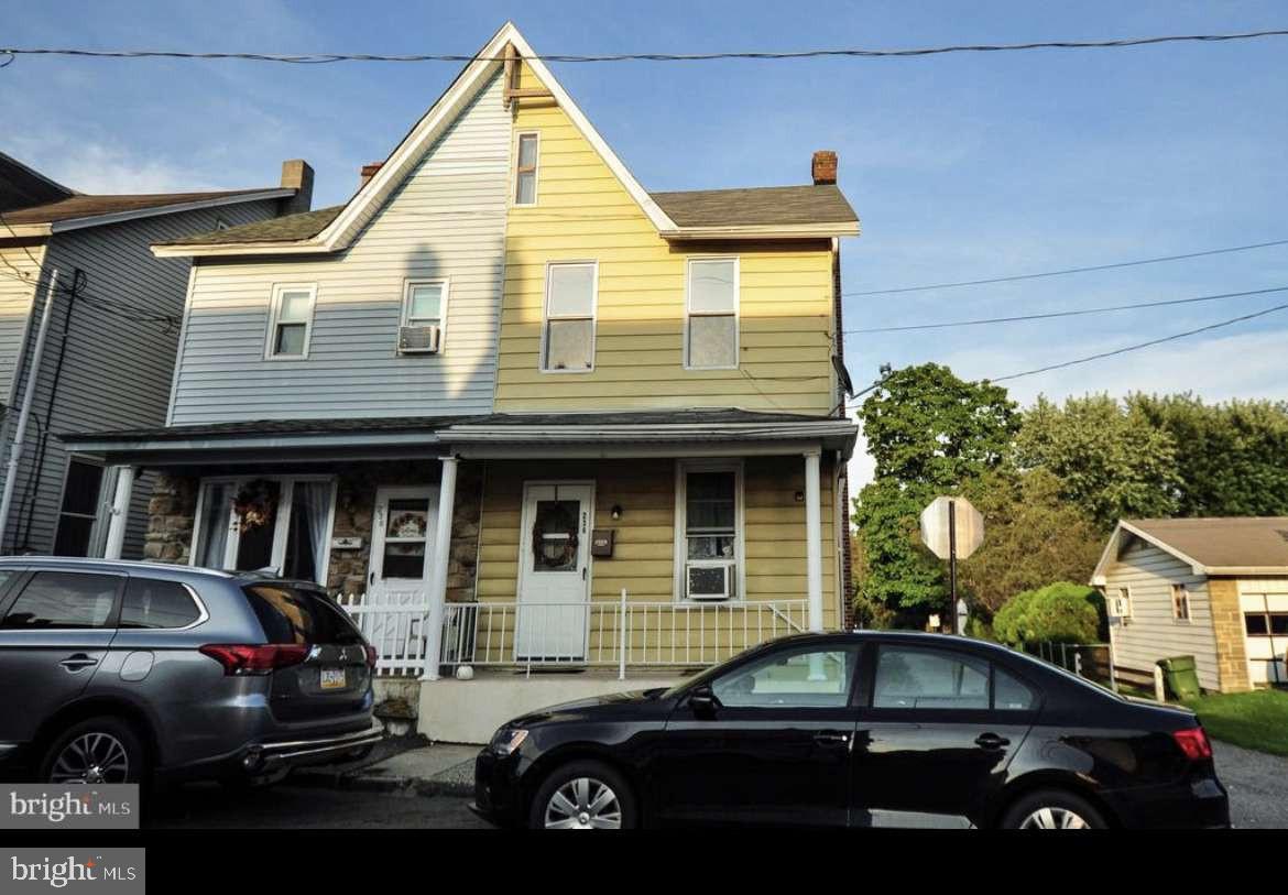 a front view of a house with parking