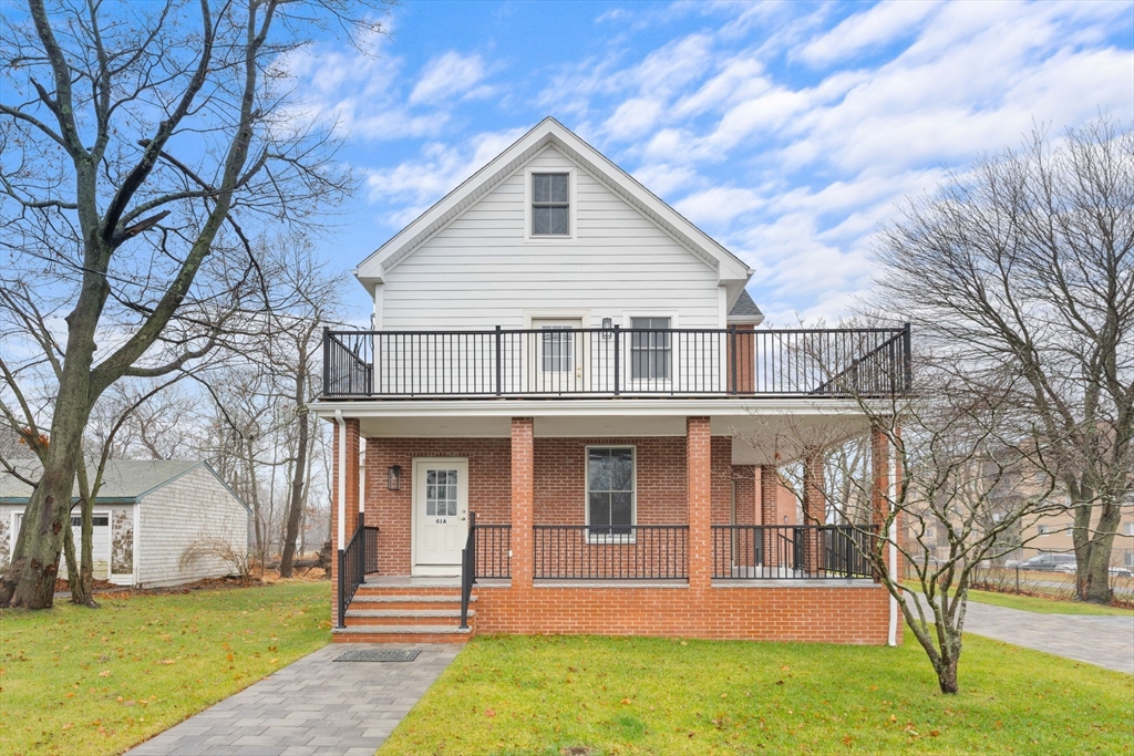 a front view of a house with garden