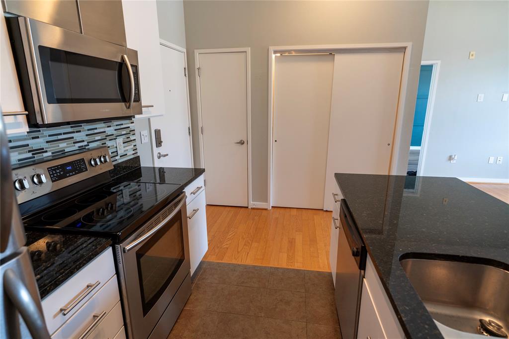 a kitchen with a stove microwave and sink