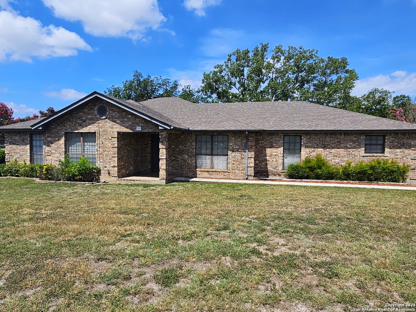 a front view of a house with a garden