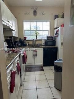 a kitchen with a stove a sink and a refrigerator