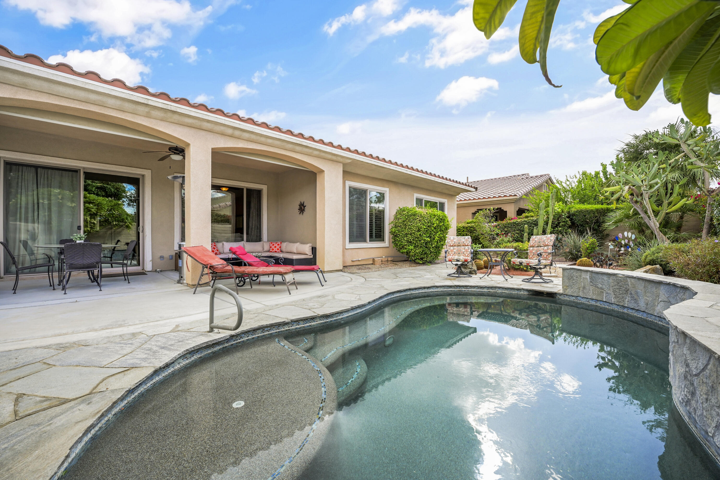 a view of a swimming pool with sitting area