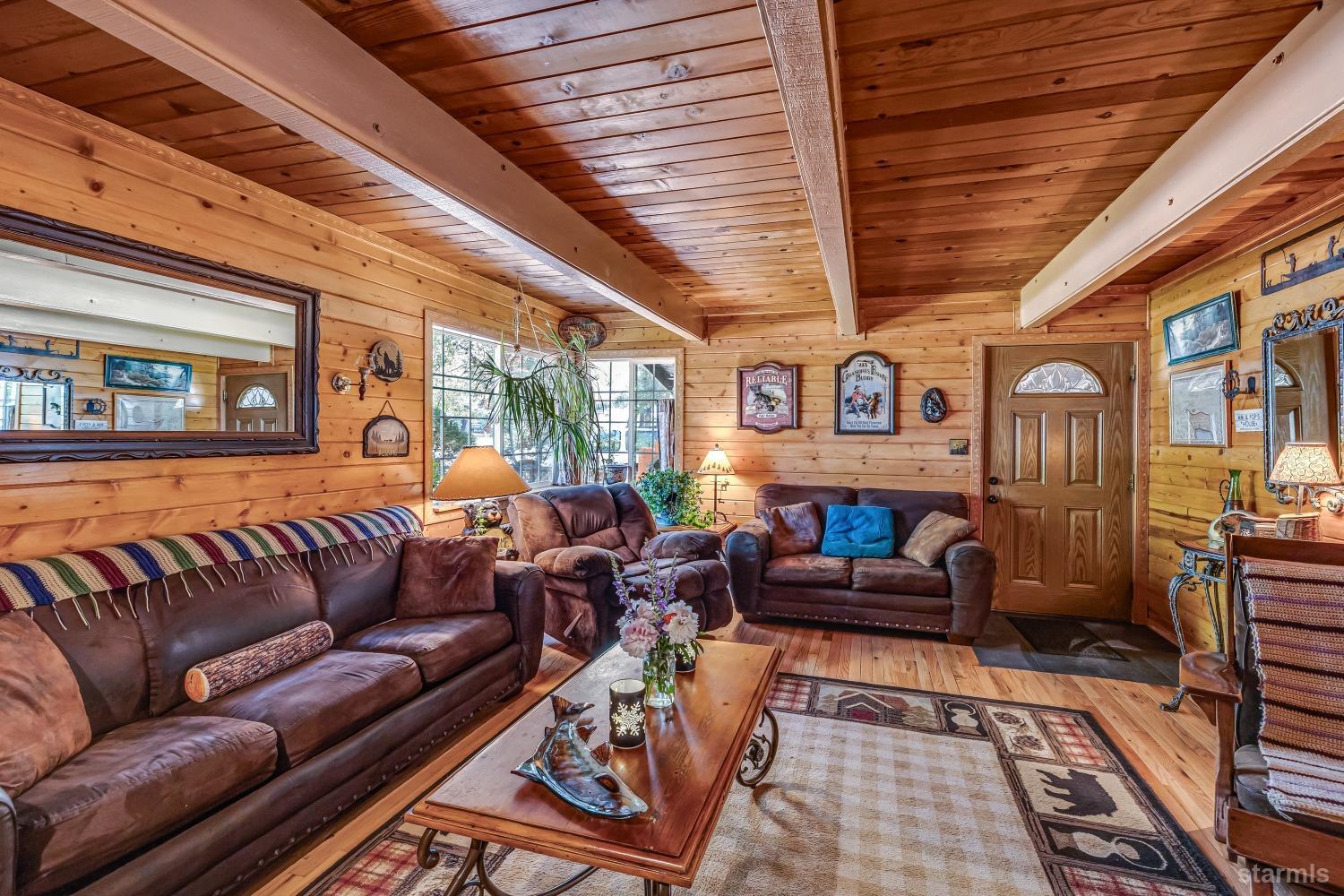 a living room with furniture ceiling fan and a rug