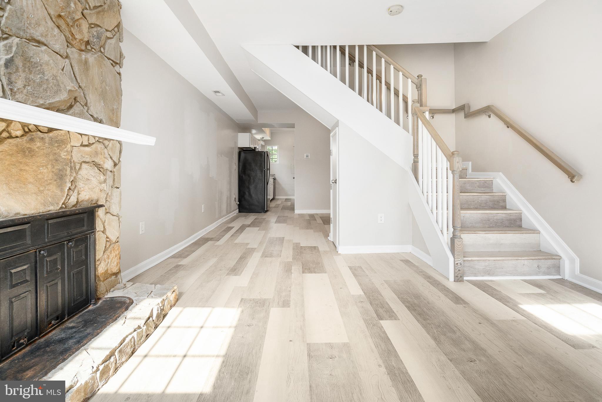 a view of entryway and hall with wooden floor