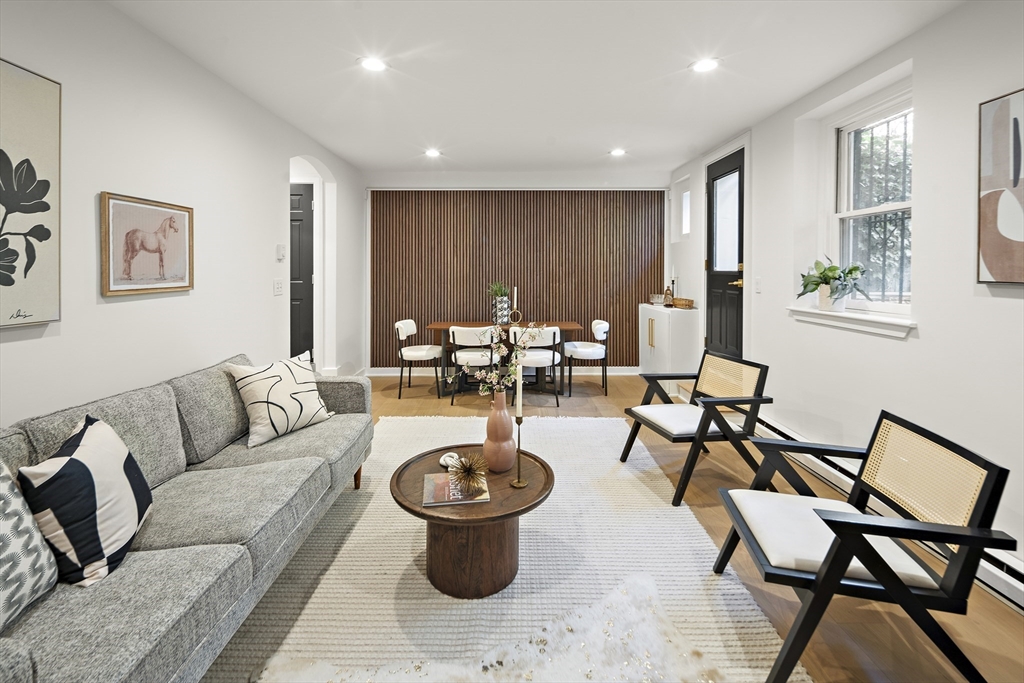 a living room with furniture a rug and a window