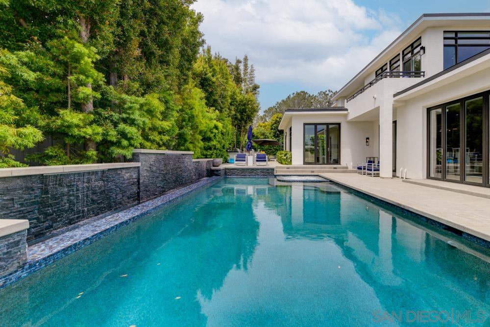 a house with swimming pool in front of it