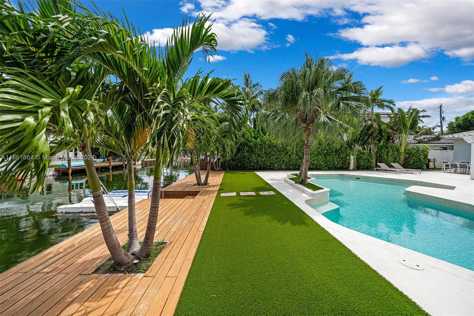 a view of a swimming pool with a patio and a yard