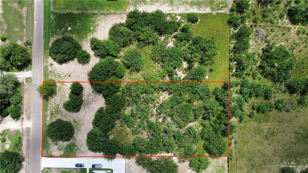 an aerial view of a house with yard