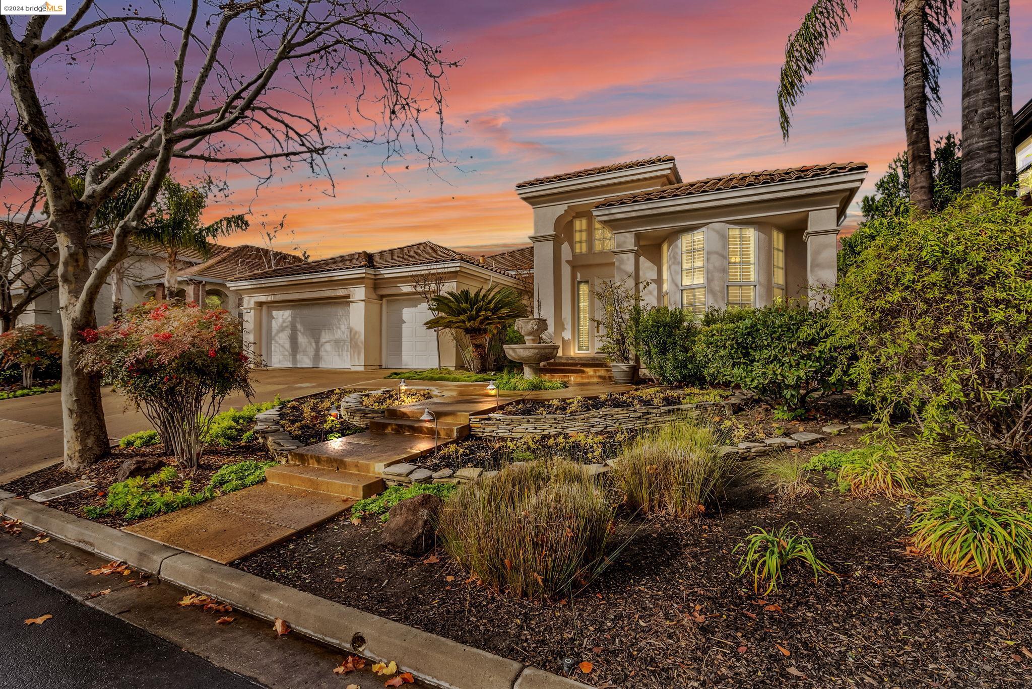 a view of a house with a small yard and plants