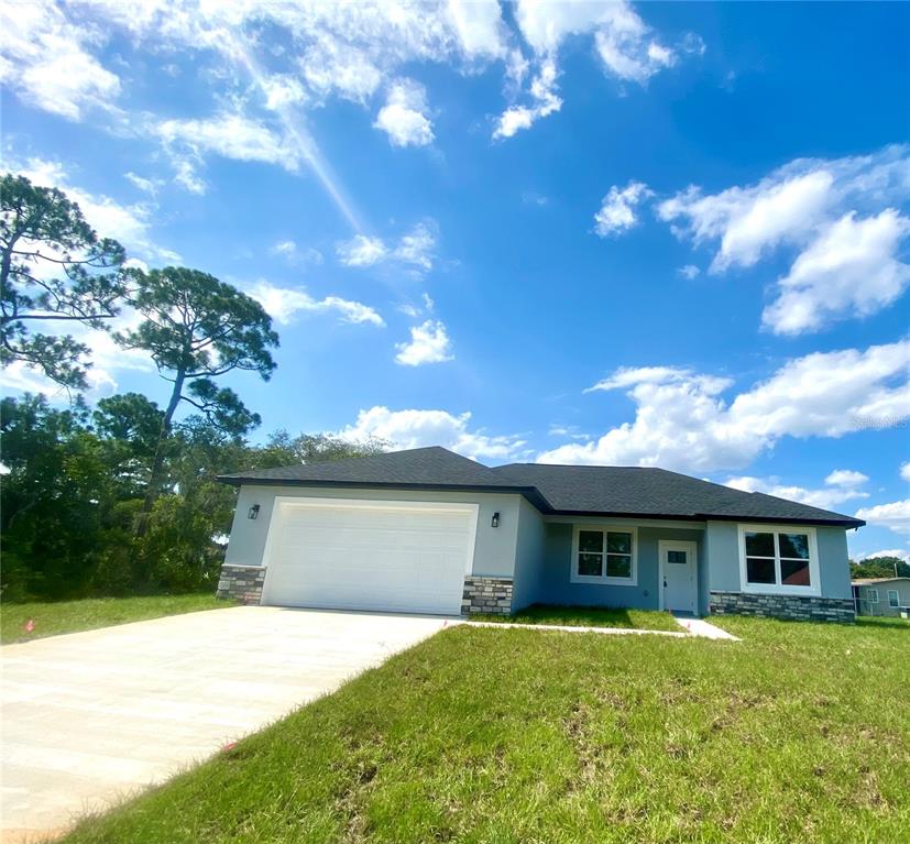 a front view of a house with a yard and garage