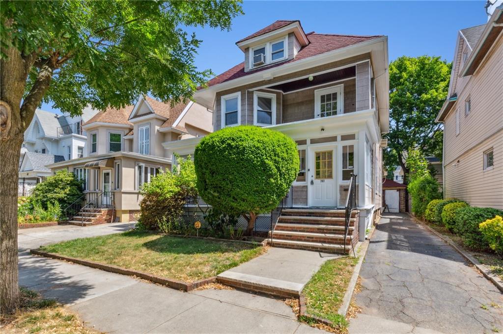 a front view of a house with garden