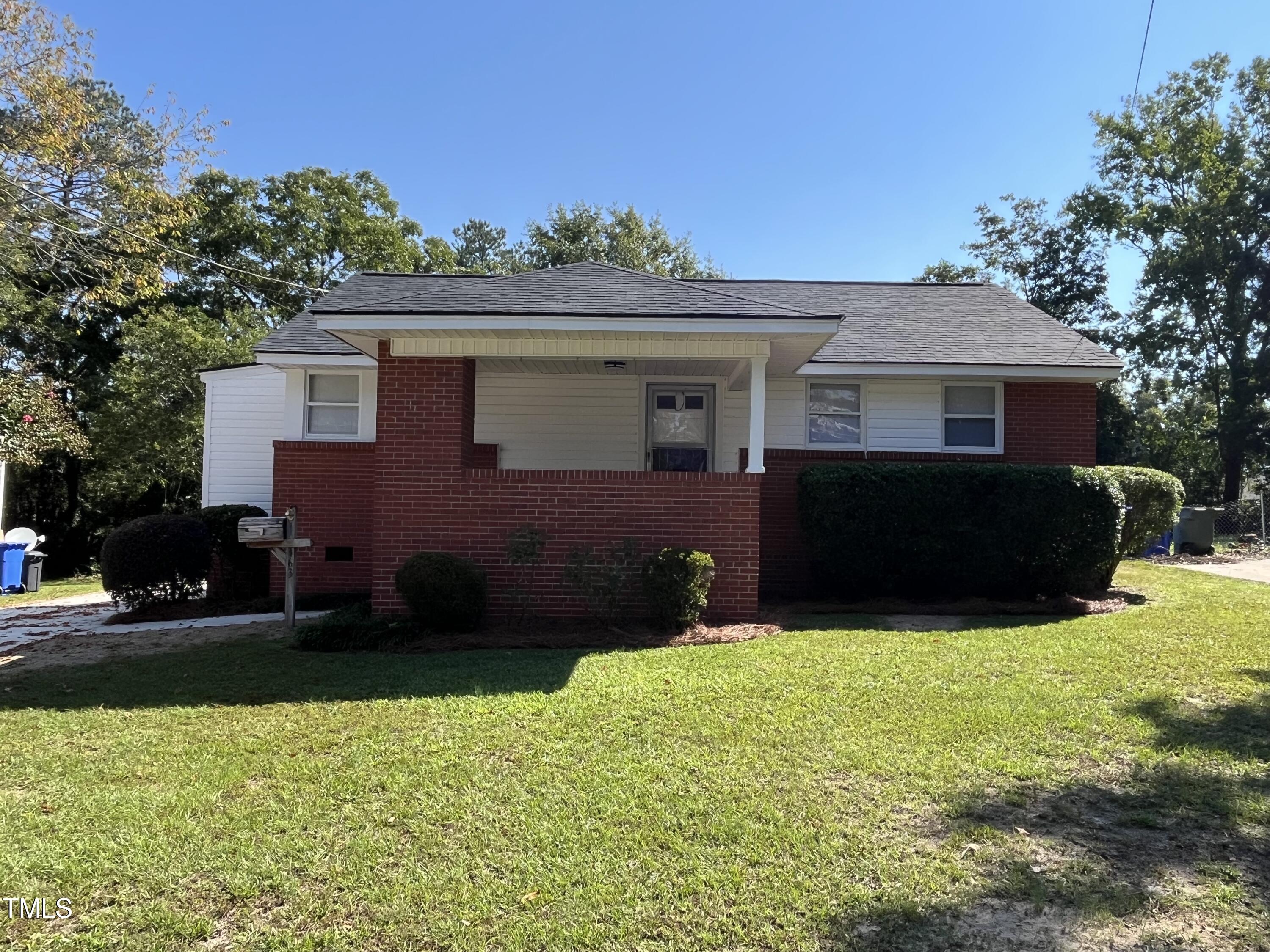 a view of house with yard and green space