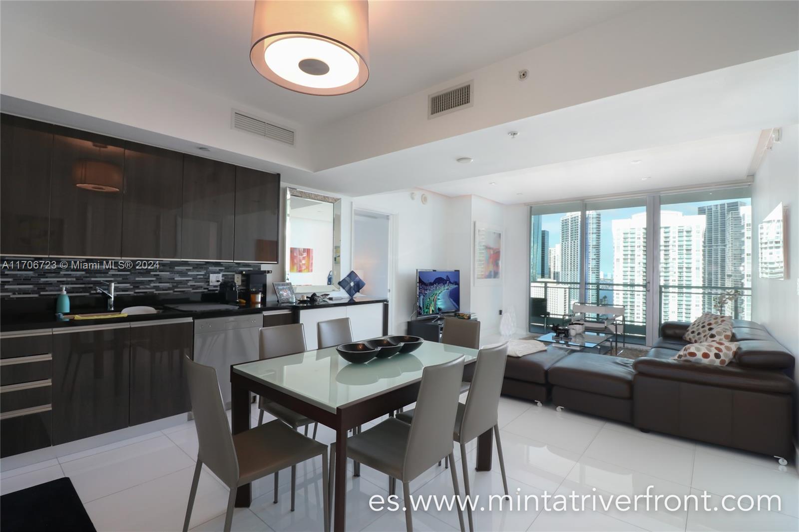 a living room with furniture a large window and a table