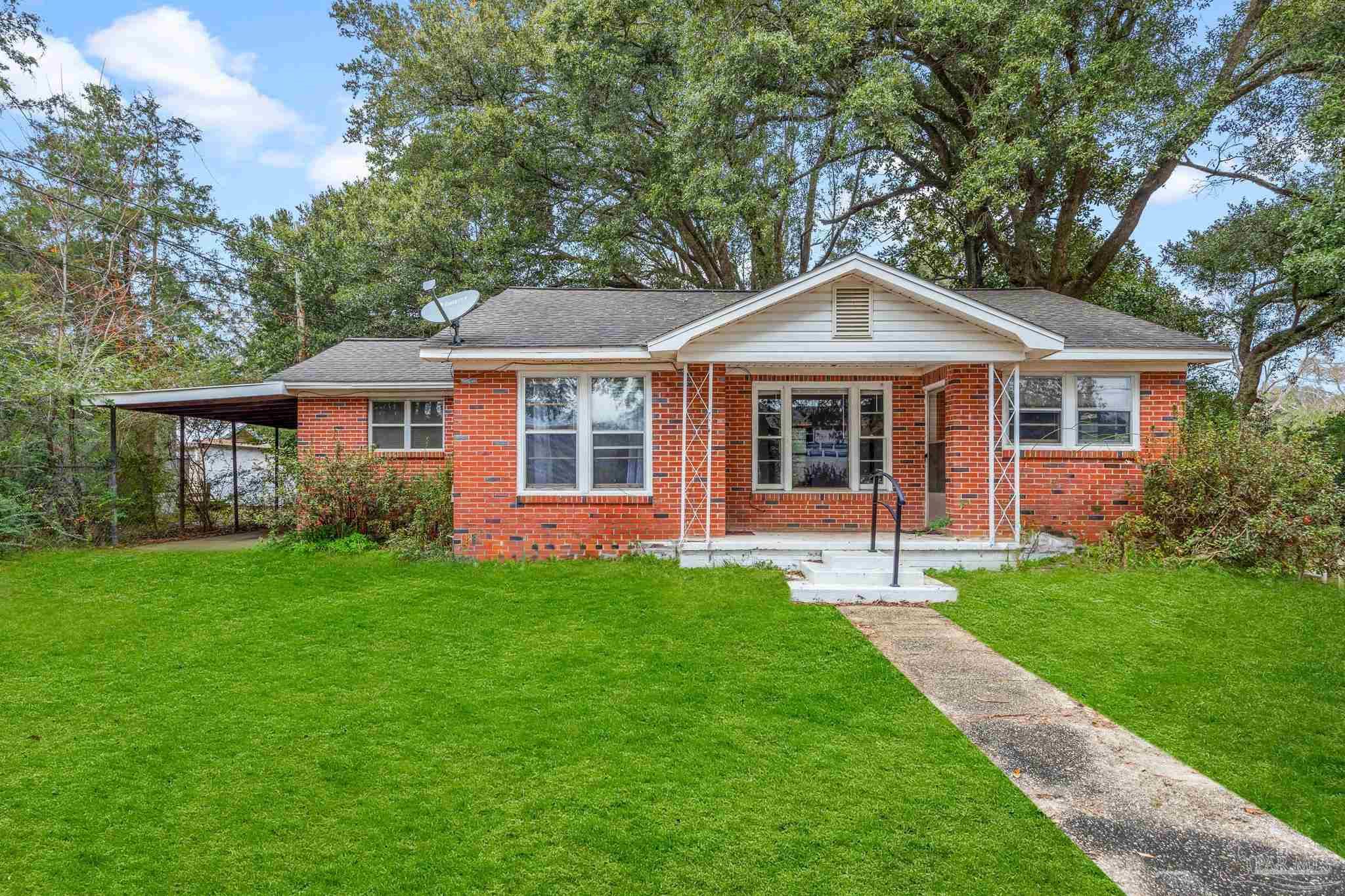 a front view of a house with a garden