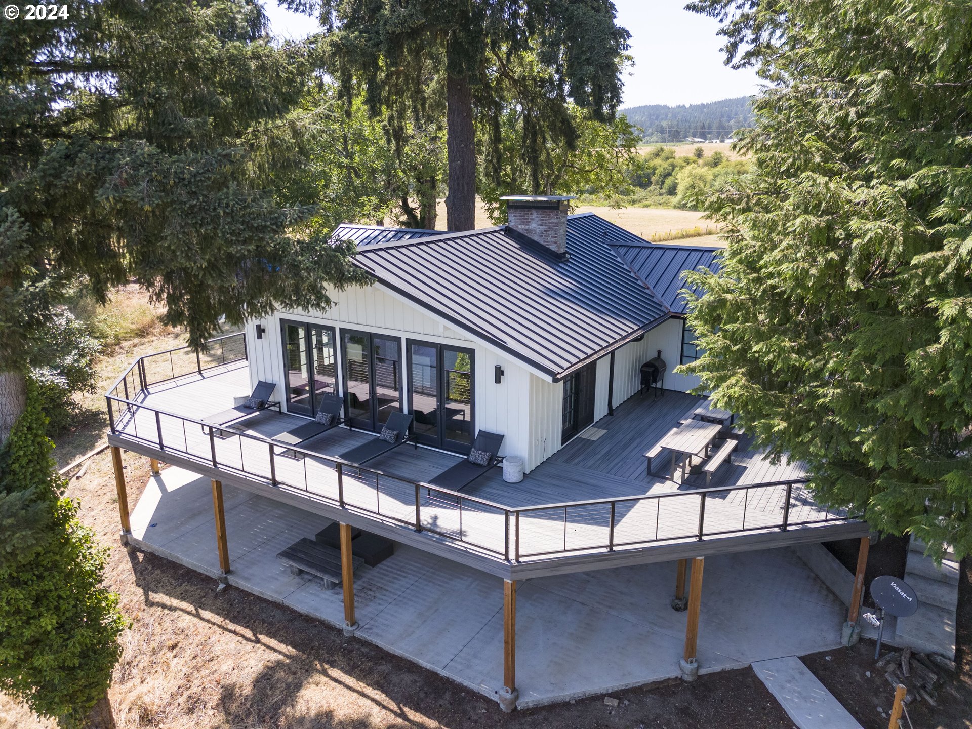 a view of house with a chairs and table in a patio