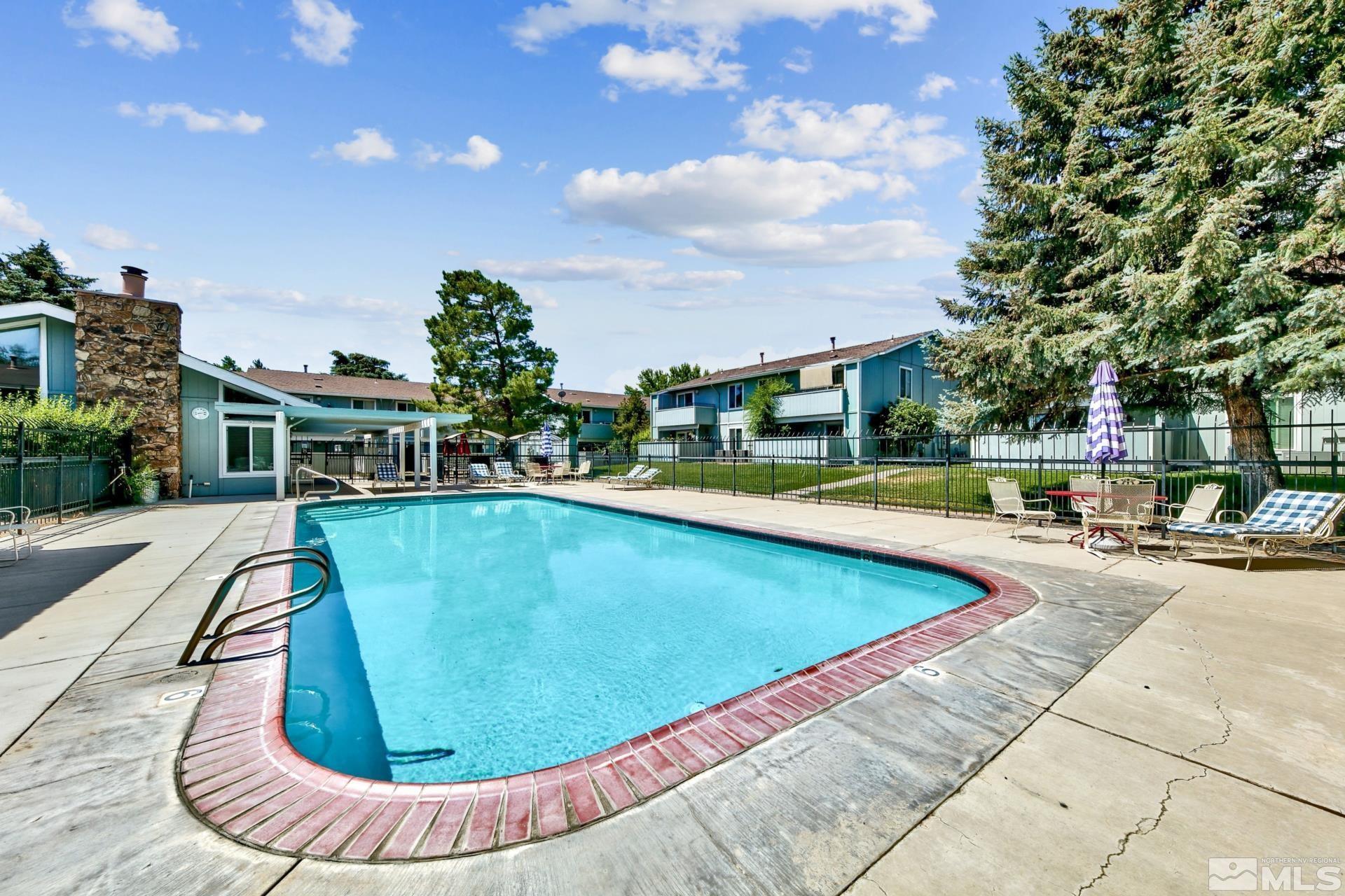 a view of a swimming pool with a lounge chair