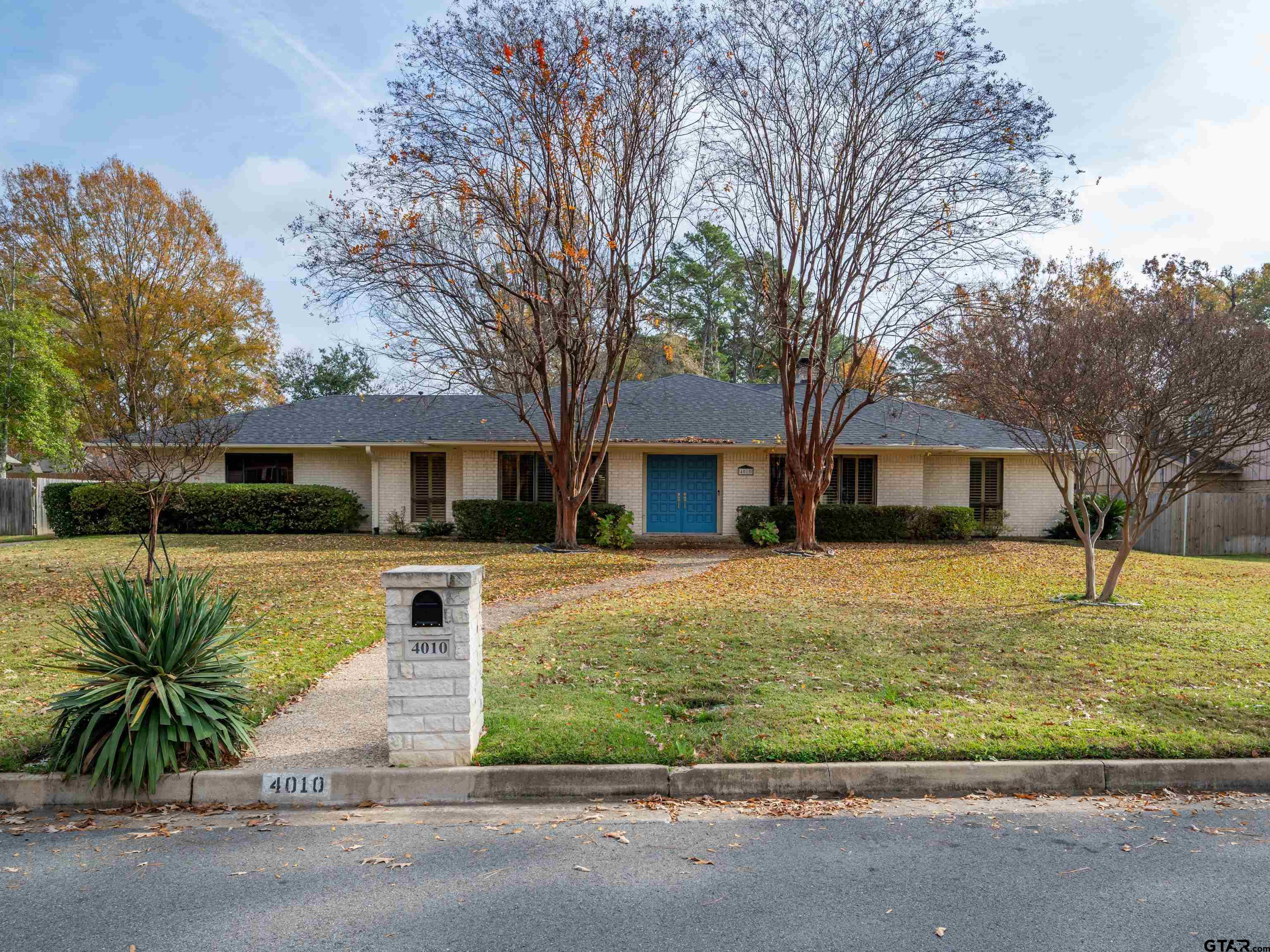 a front view of house with yard and green space