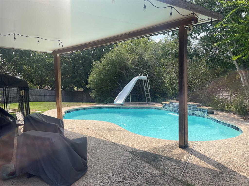 a view of a swimming pool with a patio