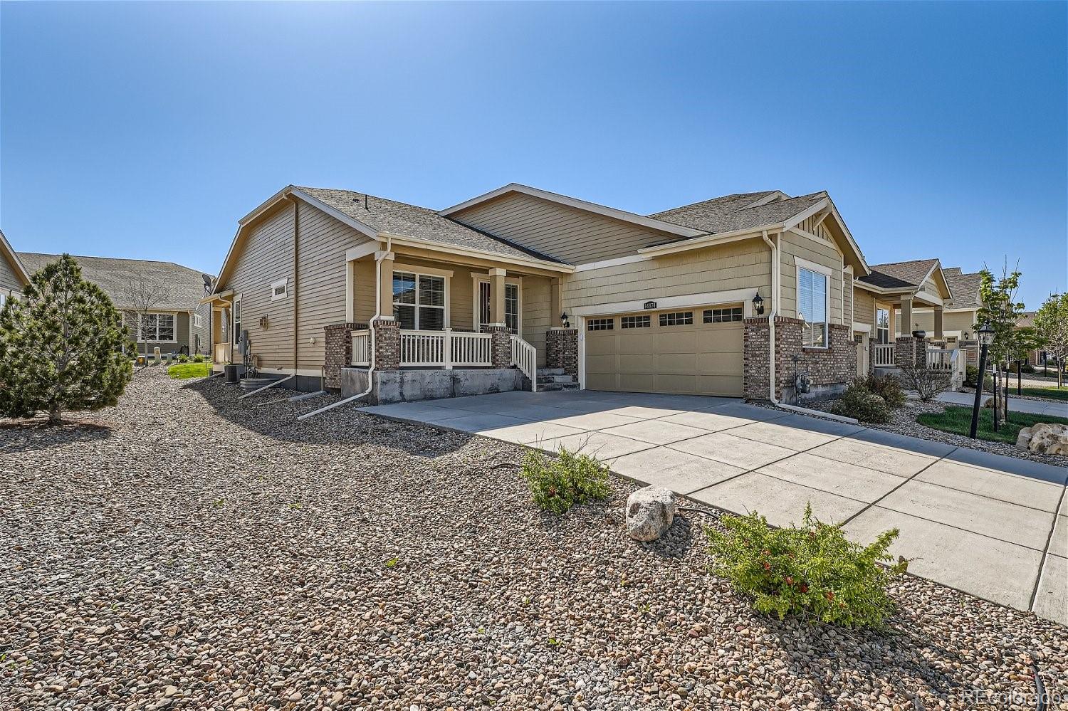 a front view of a house with a yard and a garage