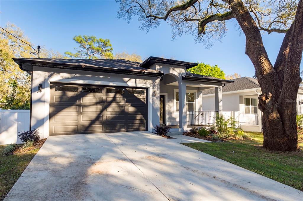 a view of a house with a tree in a yard