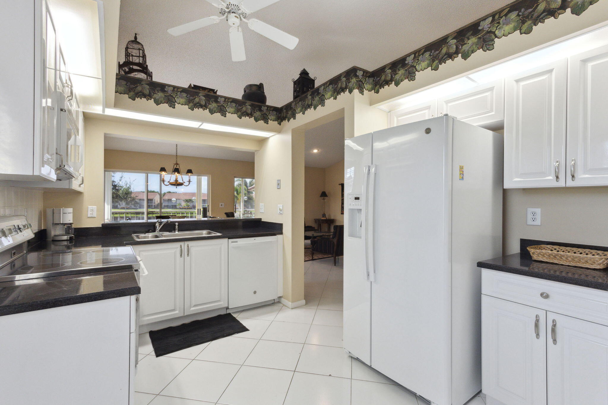 a kitchen with stainless steel appliances a refrigerator sink and cabinets