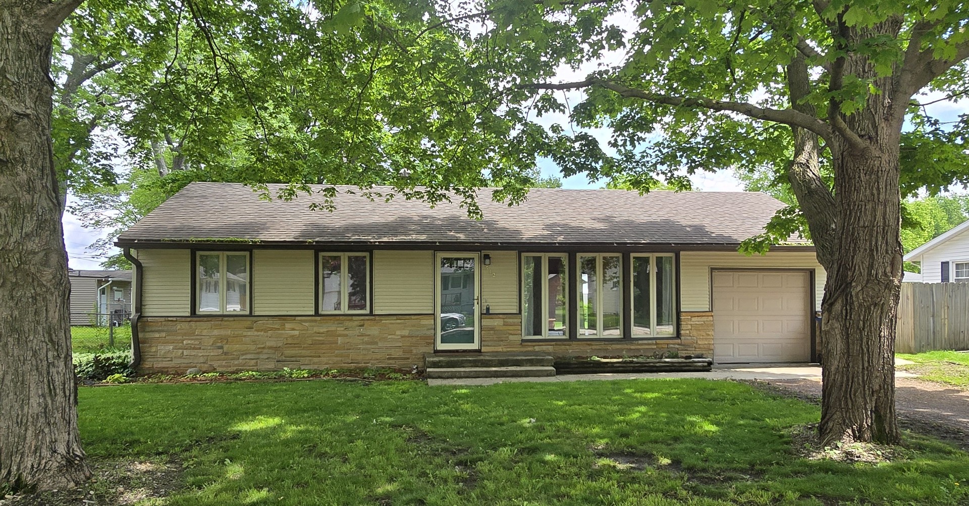 a front view of a house with a yard